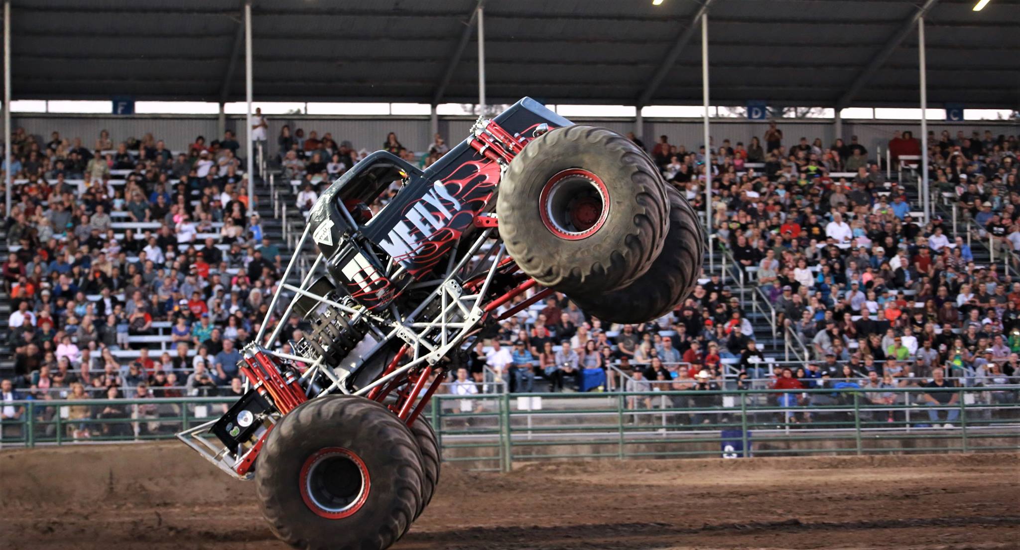 Image of a monster truck up on two wheels
